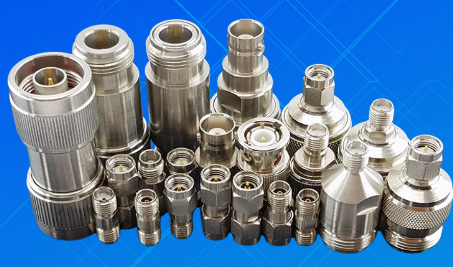 SMA connector product shot, metal housing, precision threading, gray background